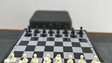A chessboard with pieces set up for a game.