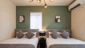 A hotel room with two beds, a bedside table with a lamp, and a window with blinds. - Fuji Terrace -EIRAN- (Gotemba)