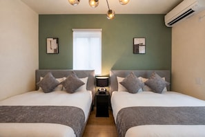 A hotel room with two beds, a bedside table with a lamp, and a window with blinds. - Fuji Terrace -EIRAN- (Gotemba)