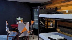 A compact room with a bunk bed, a dining table with chairs, and a small kitchenette area. - Hotel Boutique Venecia CDMX (Mexico City)