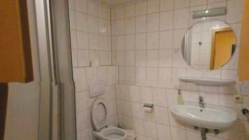 Ein Badezimmer mit Toilette, Waschbecken und Dusche.