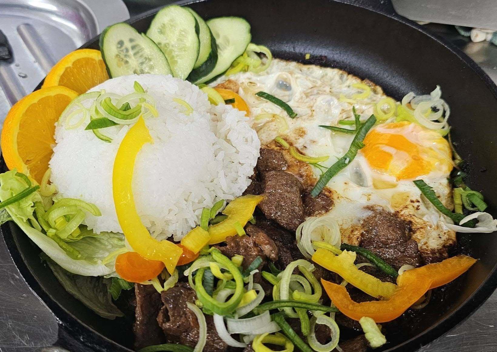 A meal with rice, beef, eggs, and vegetables.