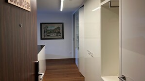 A hallway with a wooden door labeled 'Buchthaus,' a framed picture on the wall, and a glass door on the right. - Buchtoase Appartement/Fewo 4-Bett Wohnung by Interhome (Spiez)