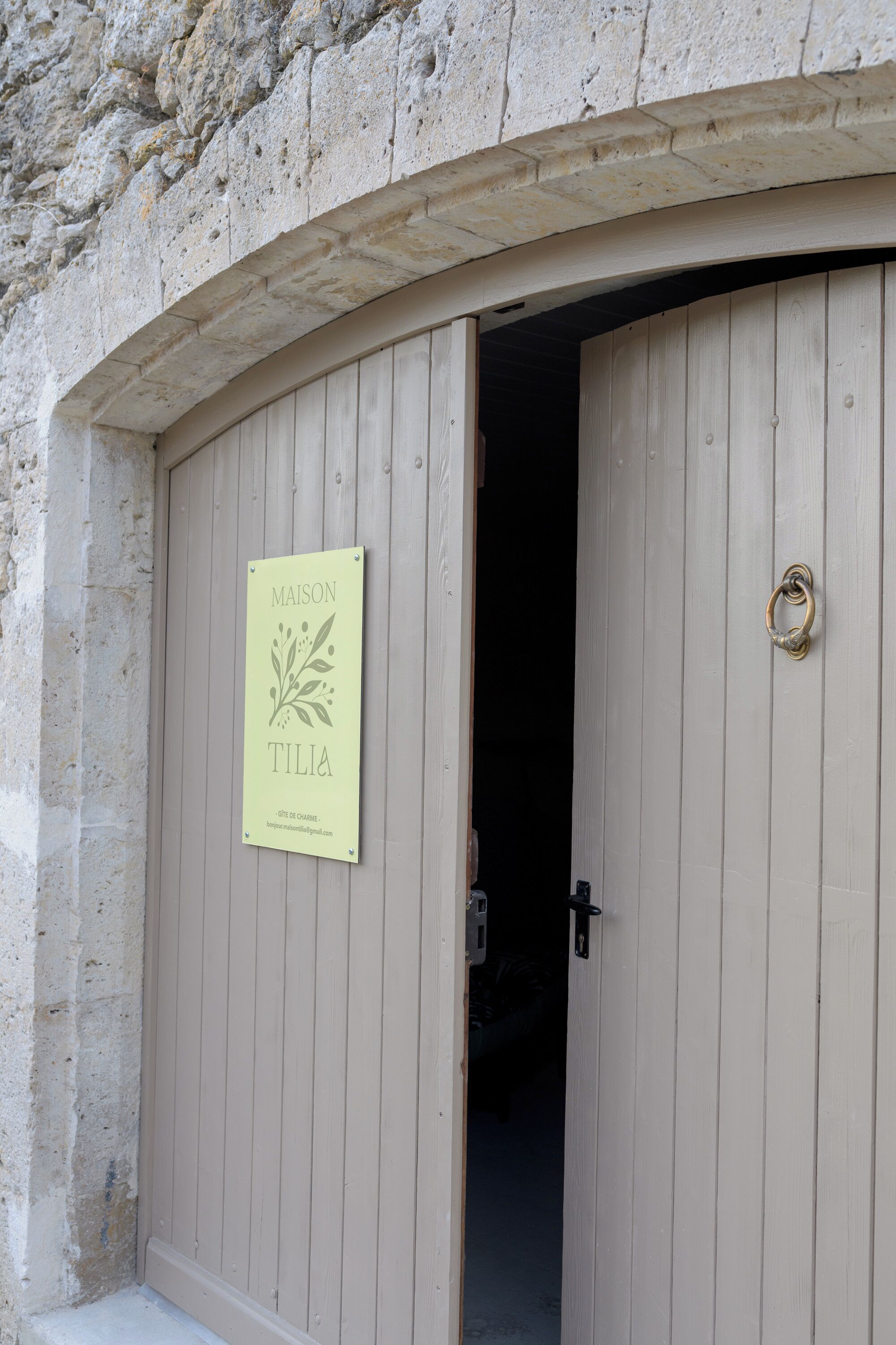 A wooden door with a sign above it.