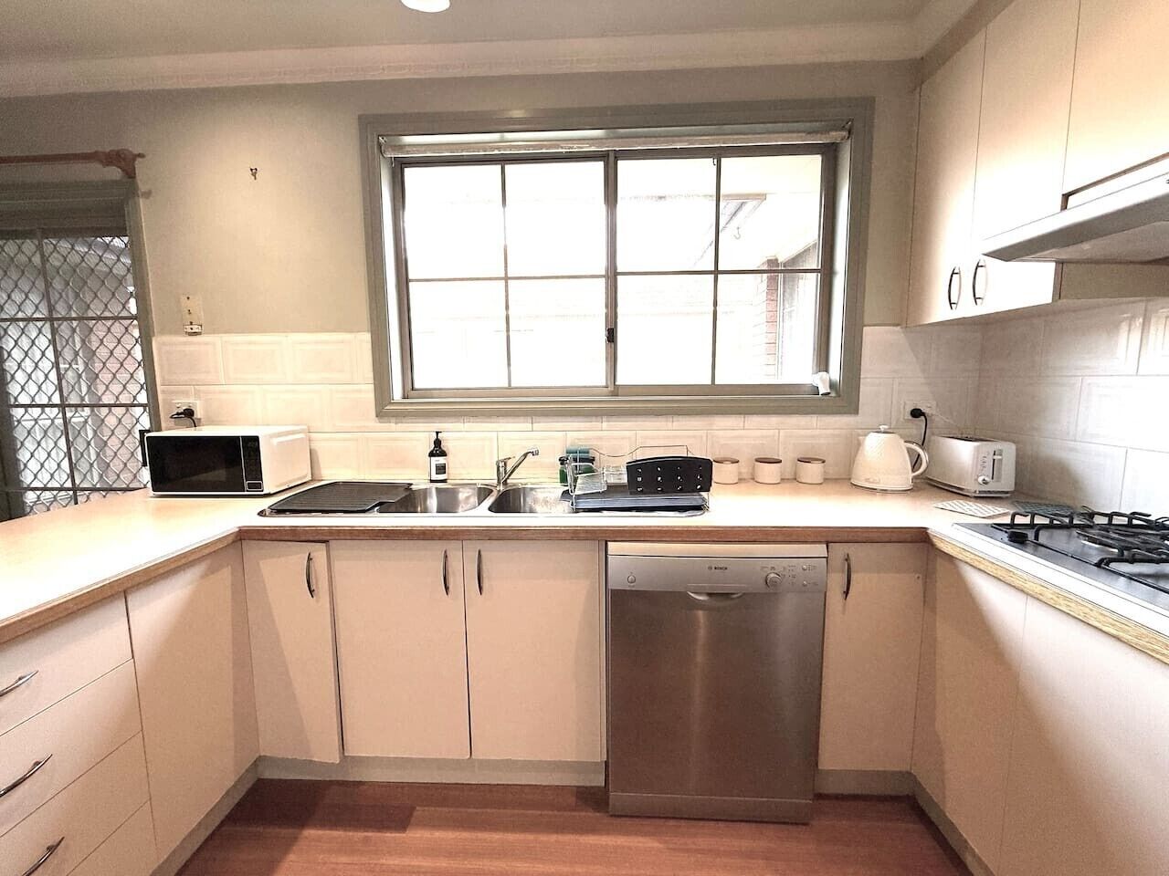 A kitchen with a dishwasher, microwave, and stove.