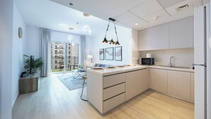 Een moderne keuken met een centraal eiland, een magnetron en een spoelbak.