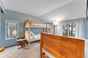 A bunk bed room with a window, a lamp, and a small table. - Mad River Valley Modern 3 bedroom & 2 bath Condo; Convenient Location (Warren)