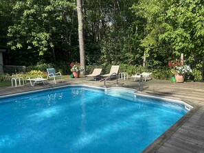 A swimming pool with lounge chairs and potted plants. - Mad River Valley Modern 3 bedroom & 2 bath Condo; Convenient Location (Warren)