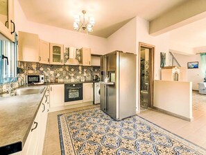 A kitchen with a microwave, oven, refrigerator, and sink. - Retro Villas - Deluxe with Pool by Interhome (Pefki)