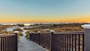 A wooden boardwalk leading to a beach with a clear view of the ocean and dunes. - 
Coastal Retreat Steps from Coligny Beach, Dining, Shops, and Celebration Park! (Hilton Head Island)