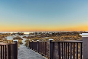 A wooden boardwalk leading to a beach with a clear view of the ocean and dunes. - 
Coastal Retreat Steps from Coligny Beach, Dining, Shops, and Celebration Park! (Hilton Head Island)