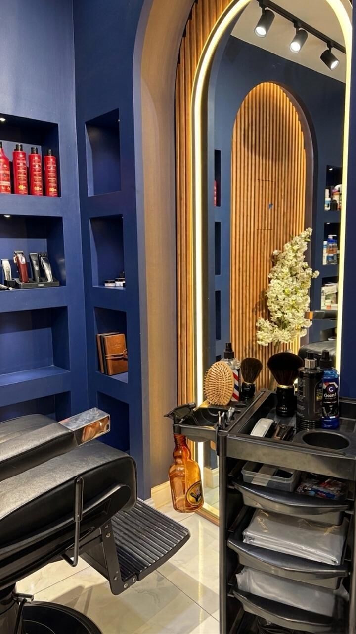 A bar area with a grill, shelves with bottles, and a counter with grooming tools.