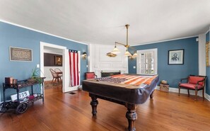 A room with a pool table, a bookshelf, and a flag. - The 1775 Colonel Benjamin Tallmadge House on the Litchfield Green (Litchfield)