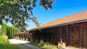 A rustic barn-style building with a gravel path leading to the entrance.