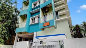 A multi-story building with a flat facade, balconies, and a visible sign that reads 'KOEL'. - Hotel O Thrissur Railway Junction (Thrissur)