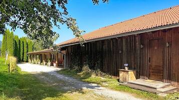 A rustic barn-style building with a gravel path leading to the entrance.