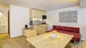 A compact kitchen with wooden cabinets, a microwave, and a coffee maker.