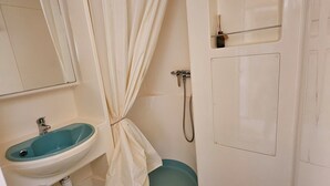 A bathroom with a sink, shower, and a towel rack. - The Chalets of Uza (Uza)