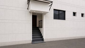 A modern building with a staircase leading to an entrance.