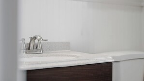 A bathroom with a white sink, a faucet, and a mirror. - Mt Washington Retreat w Dedicated Parking Pets OK (Pittsburgh)
