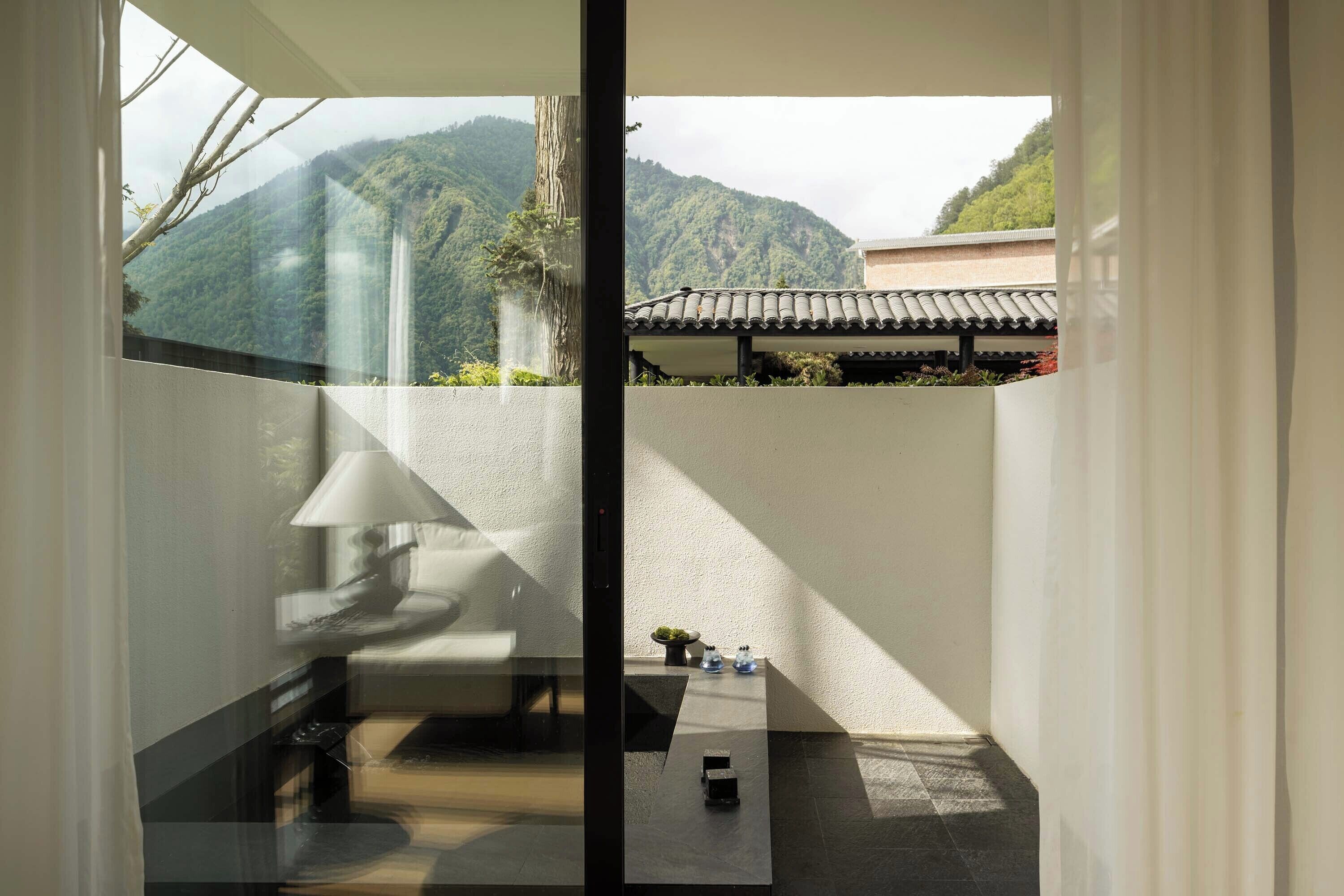 A modern interior with a view of a mountainous landscape.