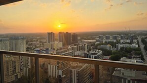 A cityscape at sunset with high-rise buildings and a clear sky. - Penthouse in the Sky (Waterloo)