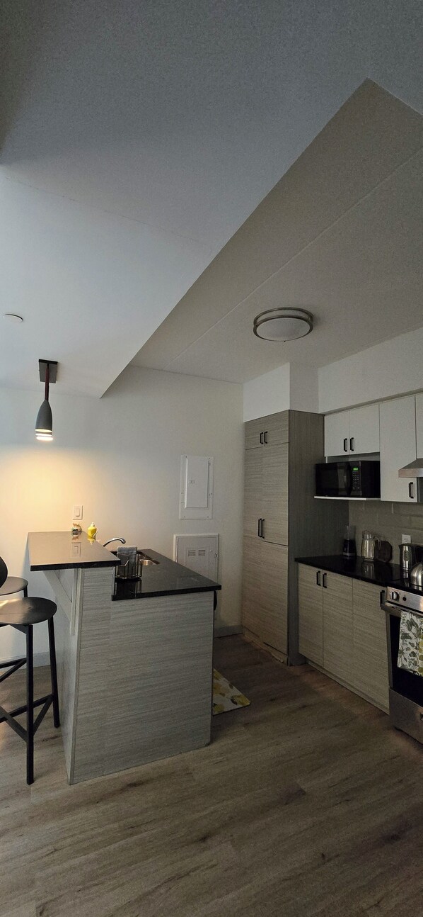 A modern kitchen with a central island, built-in appliances, and a minimalist design.