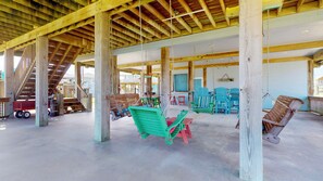 A covered outdoor area with wooden beams, swings, and seating. - Turtlely Relaxed: 3  BR, 2  BA House in Crystal Beach, Sleeps 10 (Crystal Beach)