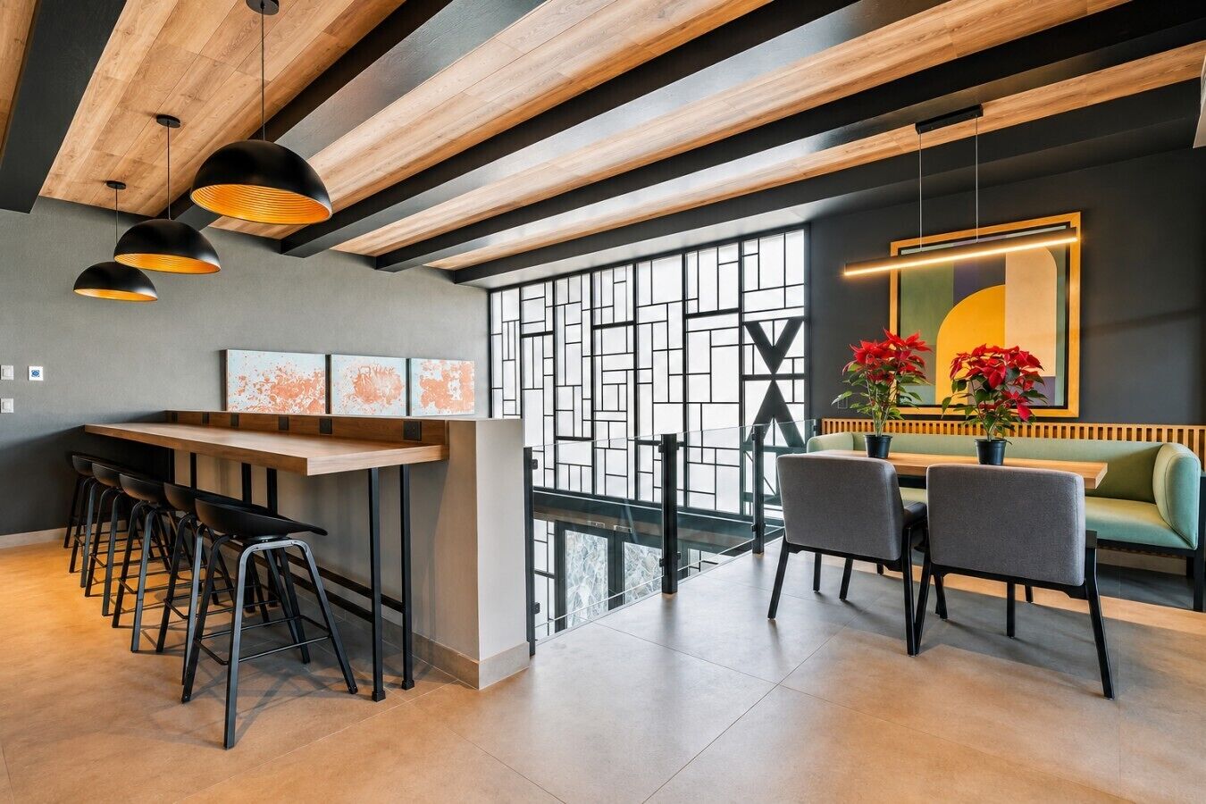 A modern interior with a bar area, seating, and a large window.