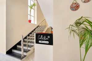 A staircase with a sign indicating a collection service.