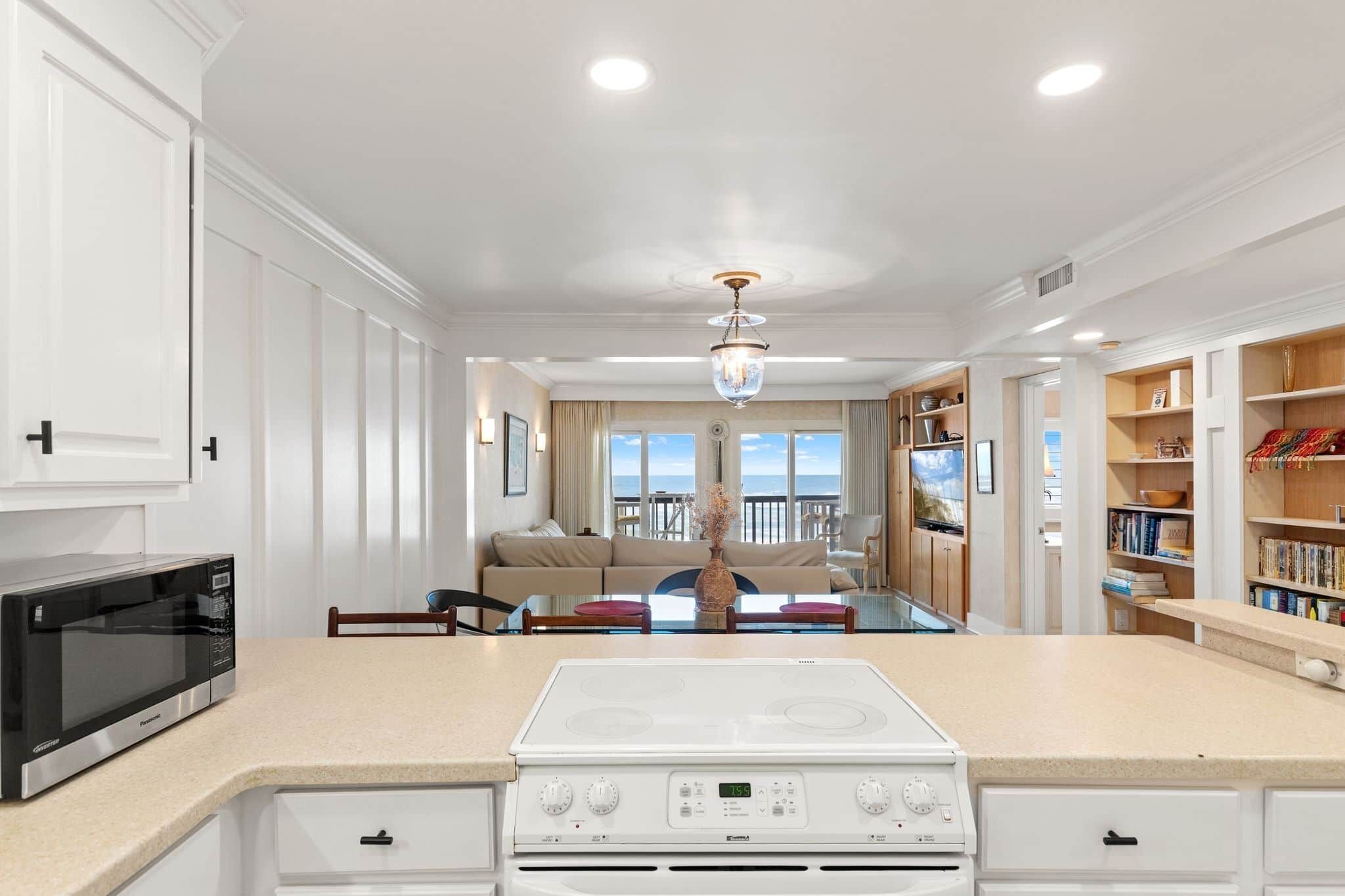 A modern kitchen with a built-in microwave, stove, and ample counter space.
