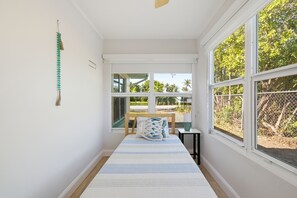 A bedroom with a bed, a window, and a view of the outdoors. - ABC Private triplex near the beach and 5 ave South 6-bedroom 3-bath in Bayshore (Naples)