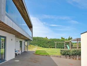 A modern building with a covered outdoor area, a staircase, and a playground with a slide. - Bay House With Sea Views (Bude)