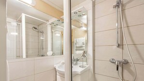 A modern bathroom with a glass shower enclosure, a sink, and a mirror. - Residence Arcelle, Ski In-Out with WiFi in Val Thorens, “V1” by Versant Collection (Val Thorens)