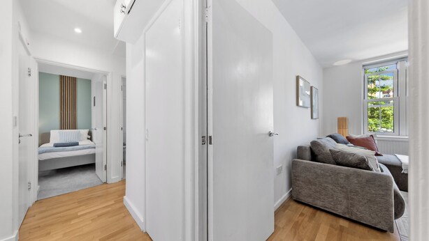 Une chambre moderne avec un lit, un canapé et une fenêtre.