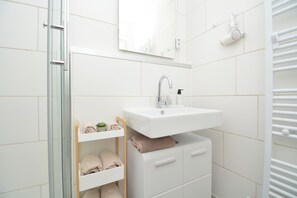 Shower, hair dryer, towels, soap