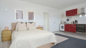 Een slaapkamer met een bed, nachtkastjes en een nachtkastje met een lamp.