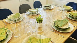 A dining table set with plates, glasses, and cutlery, arranged for a meal.