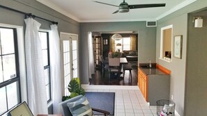 A spacious living area with a dining table, chairs, and a kitchen area with a sink and countertop. - Spacious 3bedroom house in the heart of San Antonio with Pool/hottub and Game Rm (San Antonio)