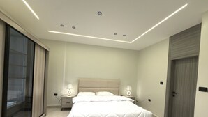A modern bedroom with a large bed, two bedside tables with lamps, a sliding glass door, and a wooden door. - Luxury 3-Bedroom Family Apartment, Prime Location, Free WiFi & Free Parking (Amman)