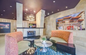 A lobby with a fireplace, seating area, and a large mural on the wall. - Exceptional Location - Downtown DC, Walk to Shops, Rooftop Pool, Jacuzzi, Gym (Washington)