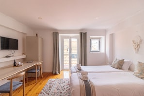 A hotel room with a bed, a desk, a television, and a window. - Bairro Alto Studio 3 · Very Central · AC (Lisboa)