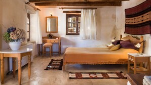 A traditional room with a bed, a desk, a chair, a mirror, a window with curtains, and a hanging lamp. - Kamares Private Pool Stone Villa (Apokoronas)