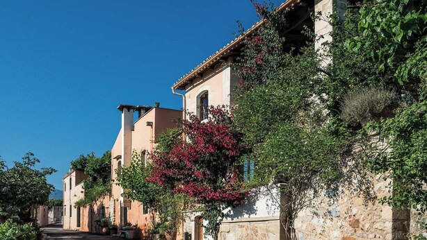 A narrow street lined with traditional buildings, some with balconies and vegetation. - Kamares Private Pool Stone Villa (Apokoronas)
