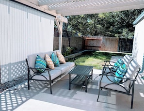 An outdoor patio with a sofa, two chairs, and a table. - Spacious Home , King Bed, Chef’s Kitchen Near UNR, Downtown & Convention Center (Reno)