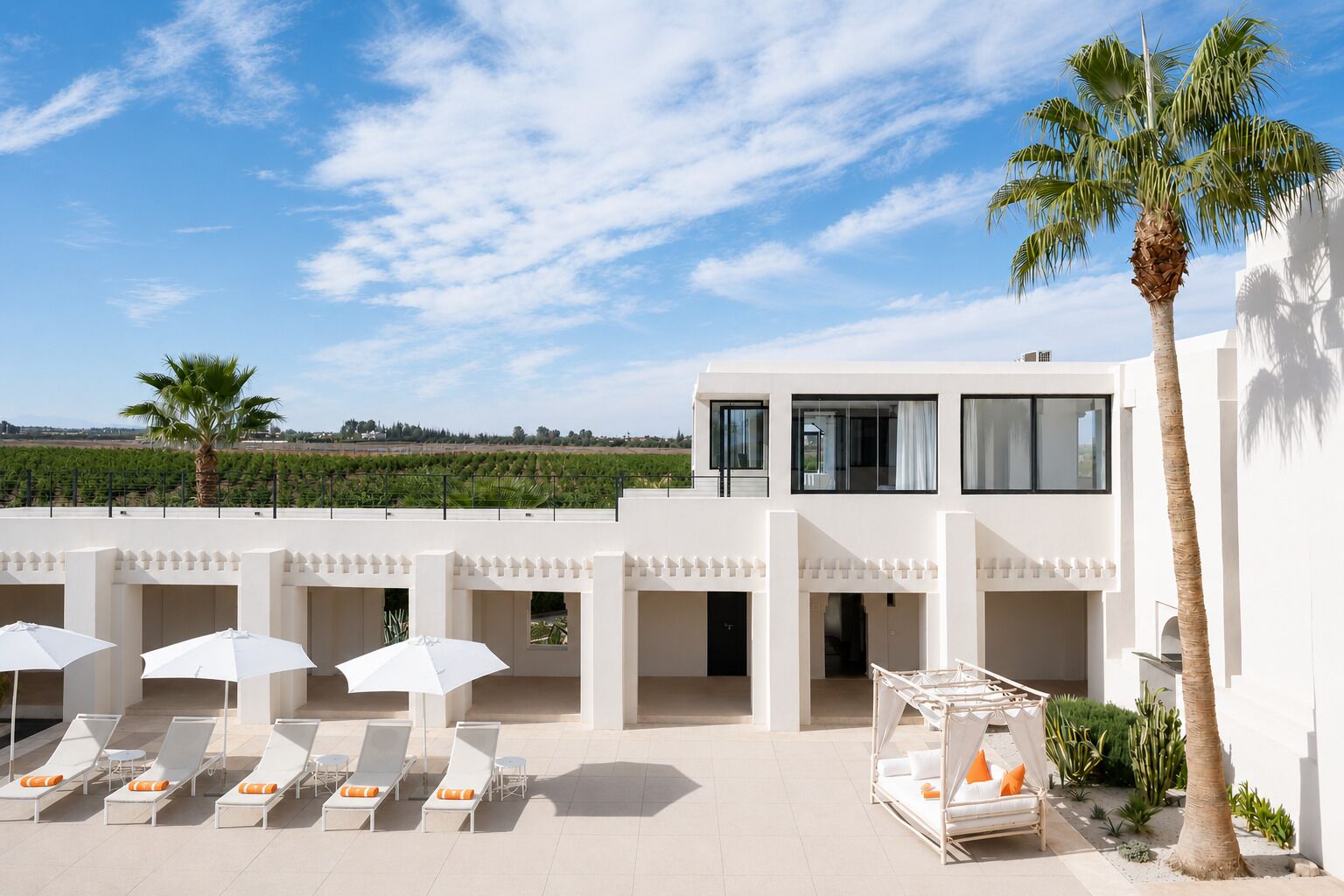 A modern villa with a rooftop pool area, including sun loungers and umbrellas.