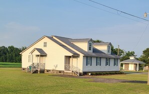 A two-story house with a front porch and a small attached garage.