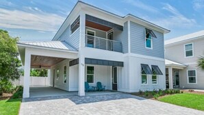 A two-story house with a covered porch, a balcony, and a small garden area. - Ahoy Matey - Emerald Waters (Miramar Beach)