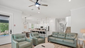 A modern living room with a sofa set, a coffee table, and a ceiling fan. - Ahoy Matey - Emerald Waters (Miramar Beach)