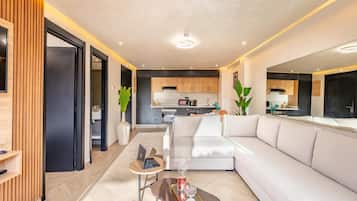 A modern living room with a sofa, a coffee table, and a laptop.